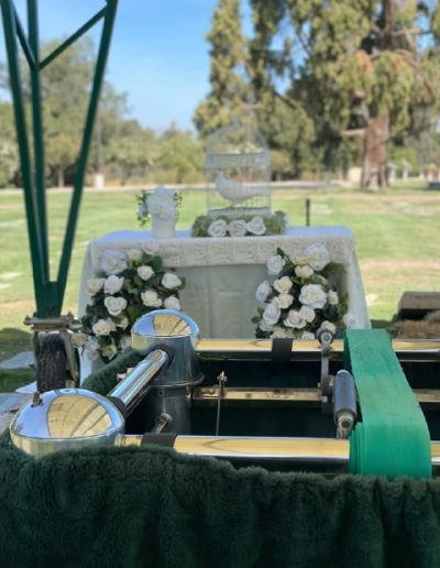 A beautiful and elegant addition to a wedding ceremony, the white dove cage surrounded by flowers